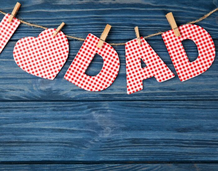 Composition with phrase I LOVE DAD for Father's Day on wooden background